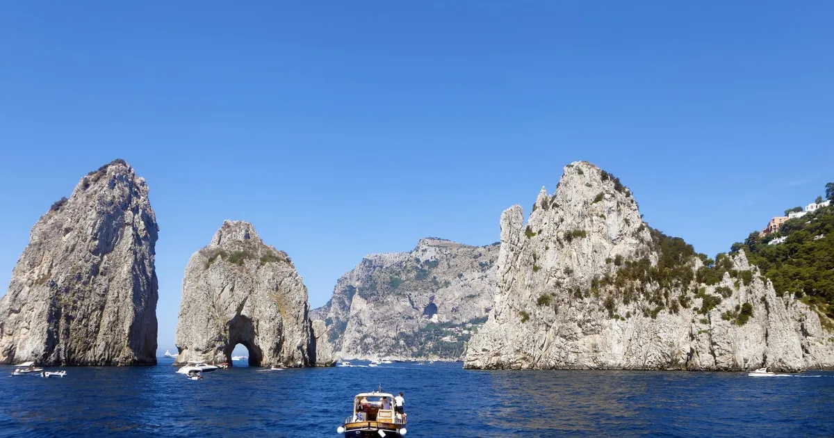 Ferry crossing the Gulf of Naples with Vesuvius in the distance on a Capri sightseeing boat tour from Naples, Italy
