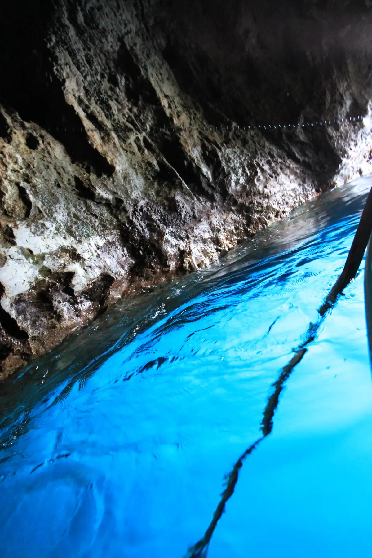 Electric blue light inside the Blue Grotto sea cave on Capri visited on Blue Grotto boat tours, Italy